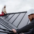 Medium shot men working on metal roof