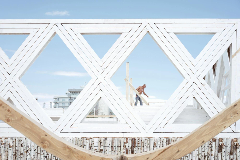 Man building bridge against sky